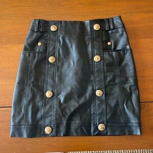 Beulah black faux leather mini skirt with gold buttons